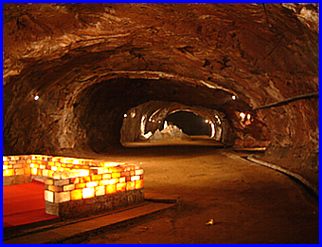 Another picture of inside a salt mine with lit electric lamps in various colours